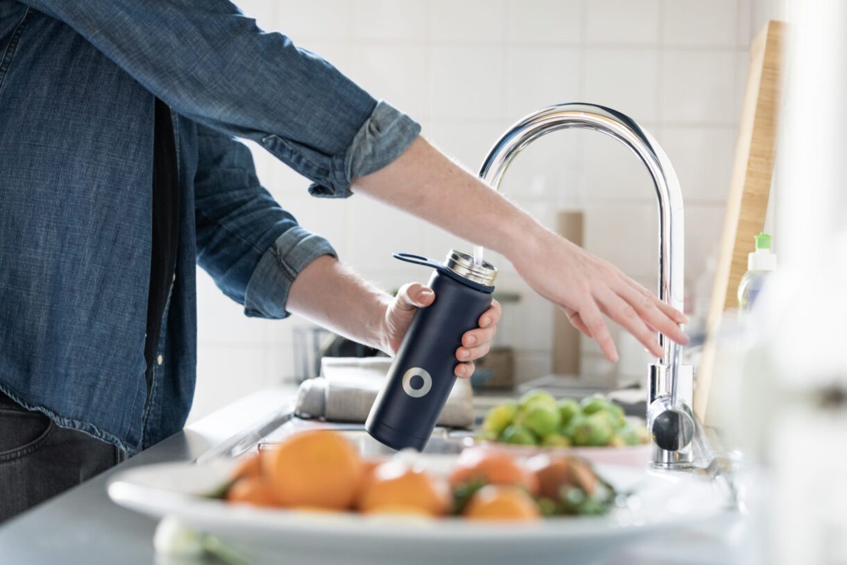 Woman filling a water bottle